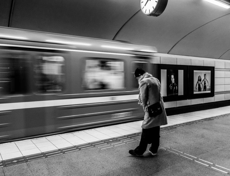 grayscale-photo-of-man-on-train-station