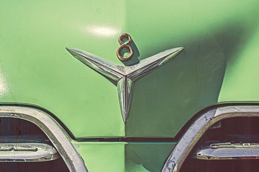 green-classic-car-with-chrome-and-gold-8-emblem