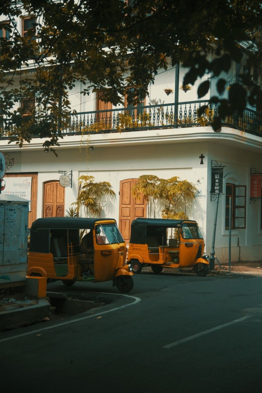 two-yellow-autorickshaws-park-near-apartment