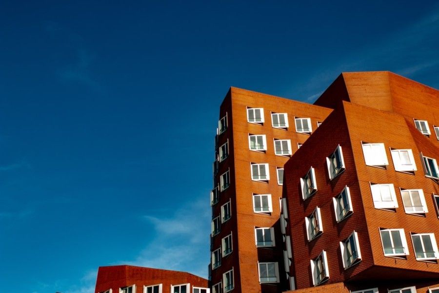 mid-rise-brown-building-under-blue-sky-during-daytime